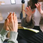 Two women engaged in a therapy session, communication and support in an office setting.