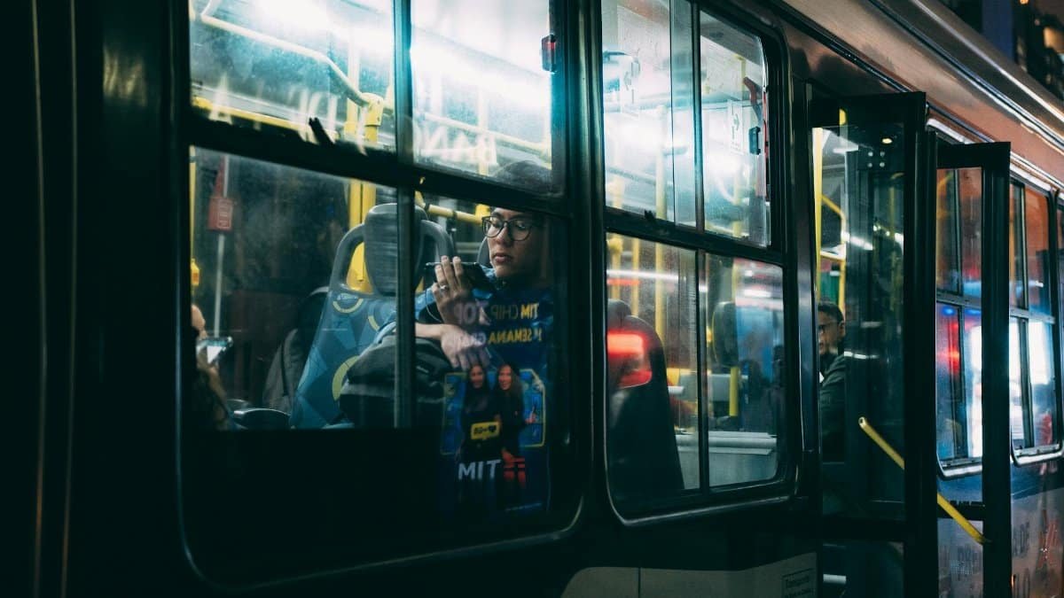 Passengers ride a city bus at night in São Paulo, capturing the essence of urban commuting.