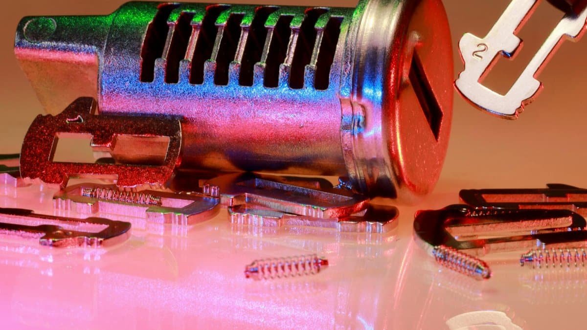 Detailed close-up of metal lock and key parts with colorful reflections, ideal for illustrating technology or security concepts.
