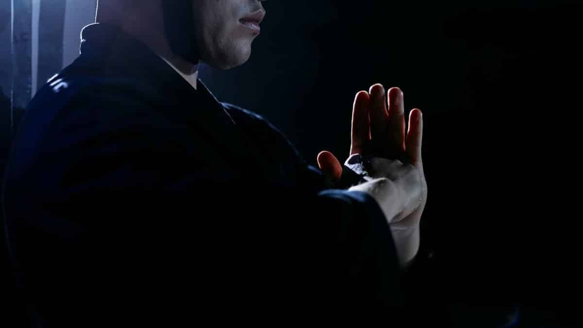 Captivating studio shot of martial artist in traditional attire, embodying focus and discipline.