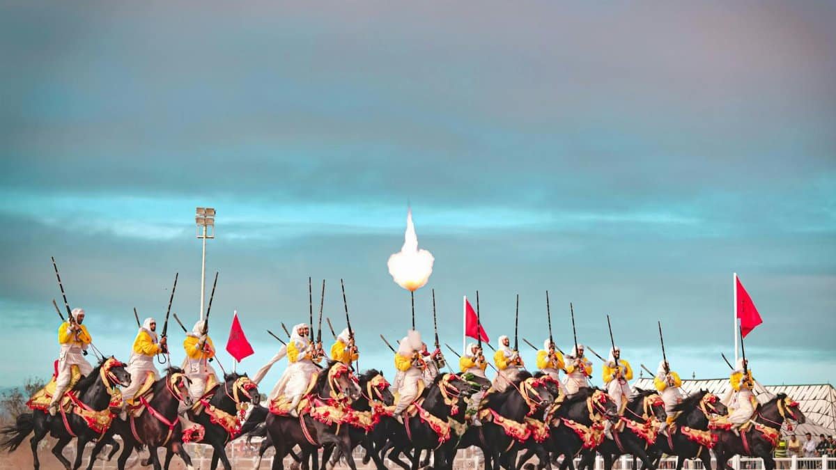 A captivating scene of Moroccan horsemen performing a traditional Fantasia charge in El Jadida.