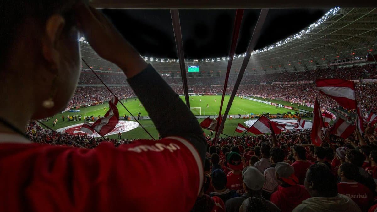 Lively soccer match at packed Brazilian stadium with cheering fans and vibrant atmosphere.