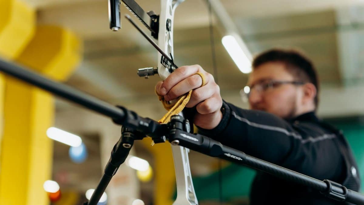 A determined archer aiming with precision indoors. Captured in dynamic detail.