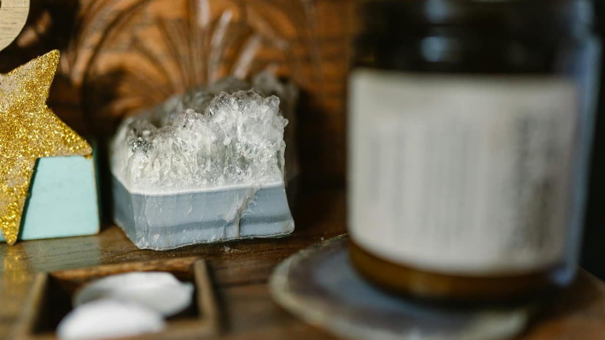 A serene still life featuring crystals, a candle, and a star decoration.