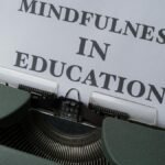 Close-up of a vintage typewriter with 'Mindfulness in Education' paper.