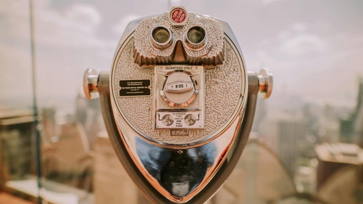 Coin operated telescope overlooking the New York City skyline on a sunny day, vintage feel.