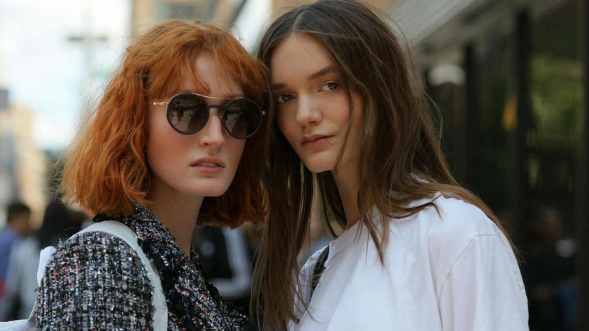Stylish women posing outdoors in New York City, showcasing urban fashion trends.