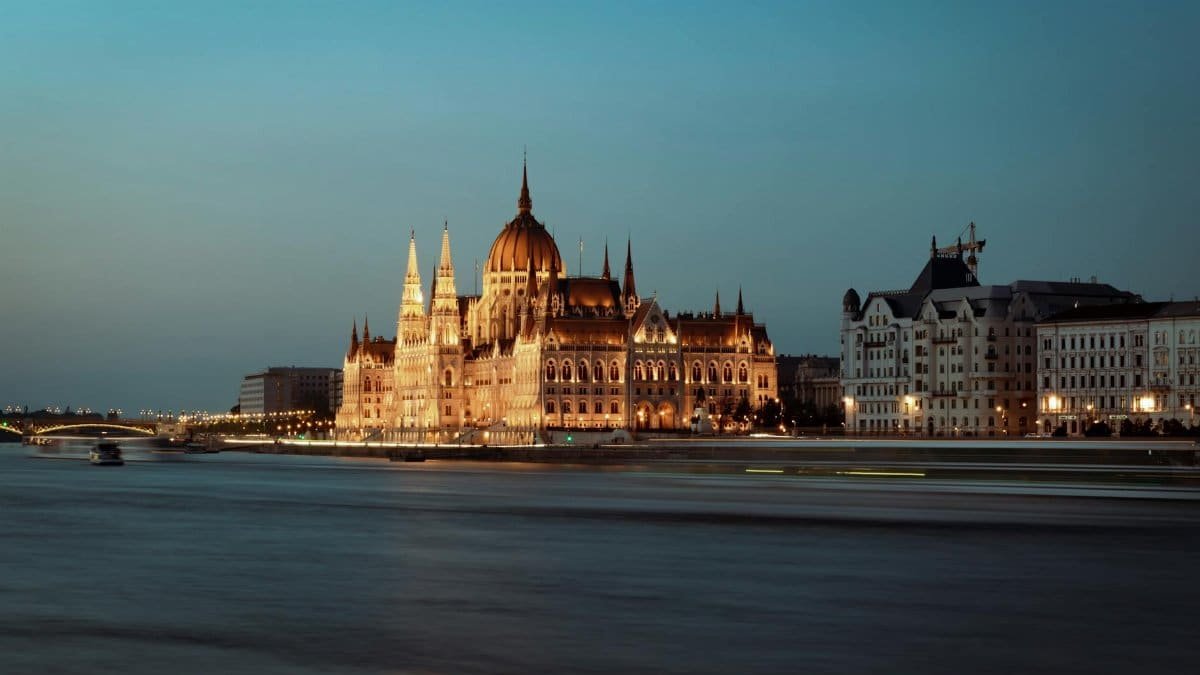 Stunning evening view of the iconic Budapest Parliament building along the Danube River.