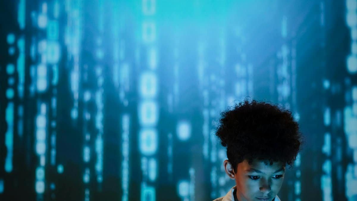 Young boy gazes at digital display creating a futuristic and modern atmosphere.
