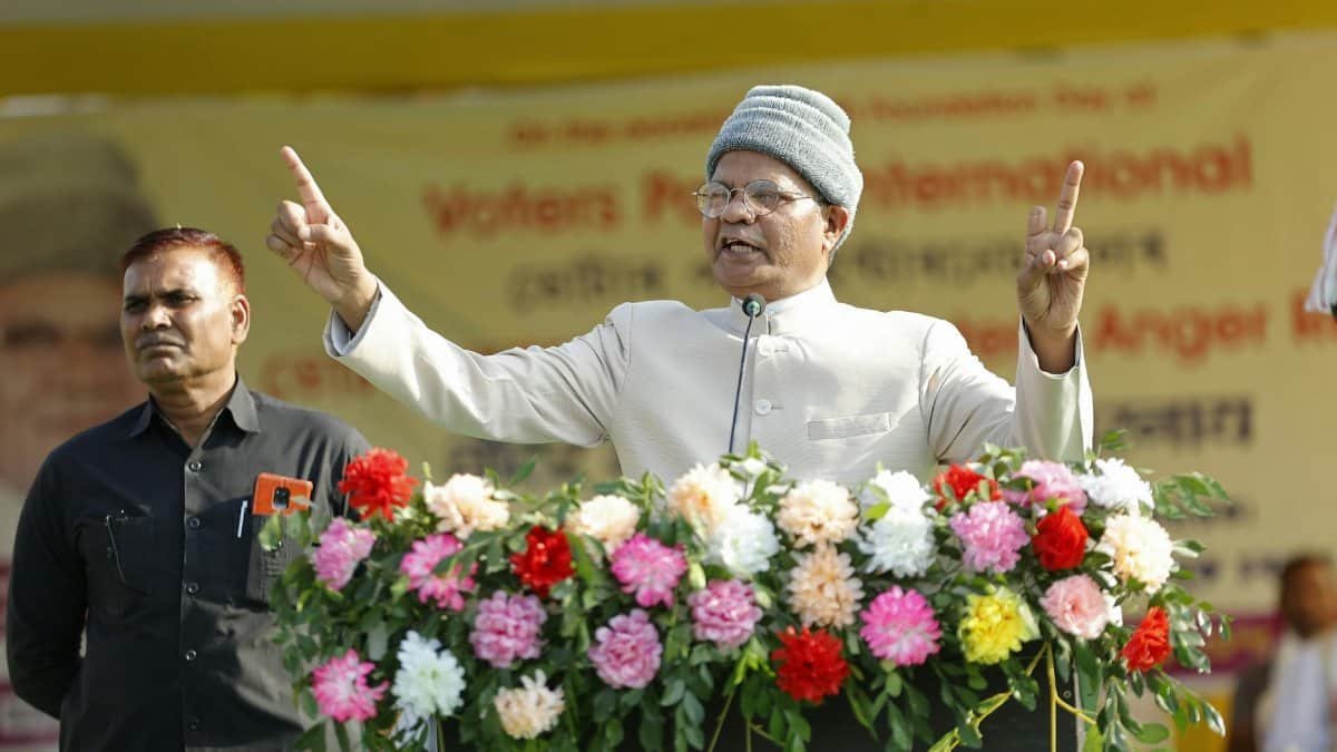 Man delivering a powerful public speech outdoors with a floral adorned podium.