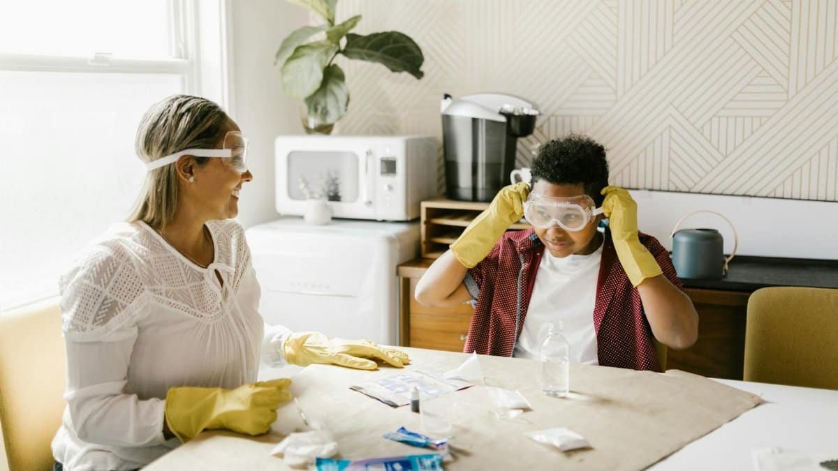 A mother and son engage in a fun science experiment at home, fostering creativity and learning.