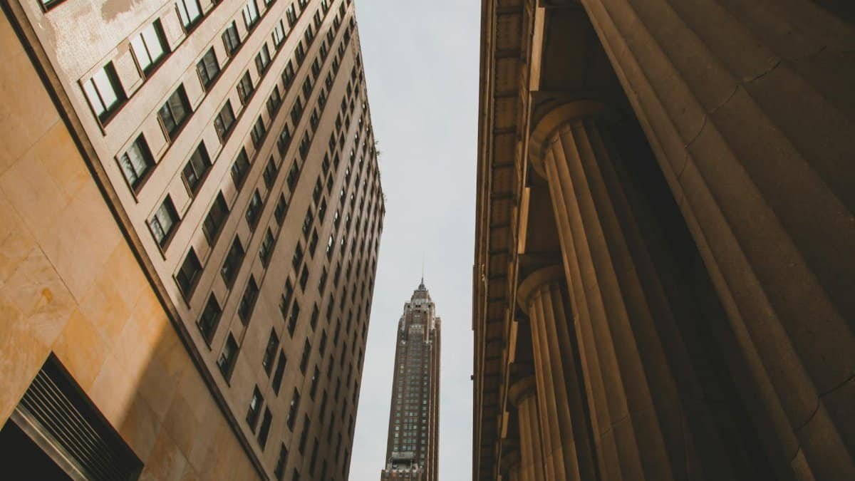 Street-level view of iconic skyscrapers and classic architecture in New York City.