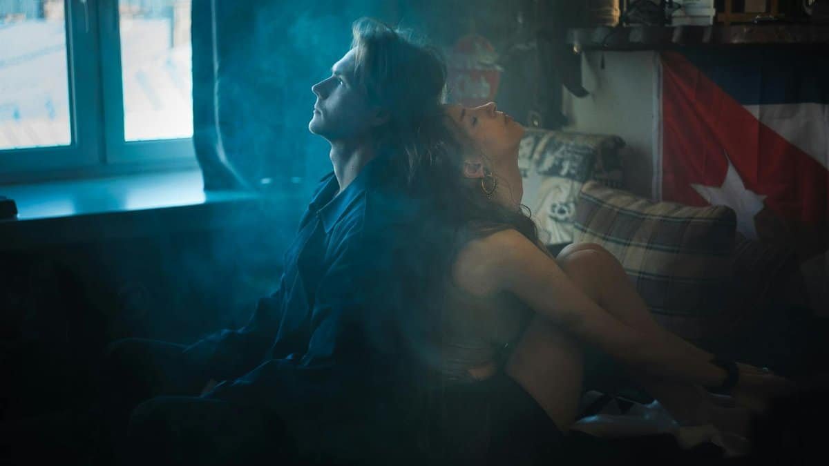 Dramatic and intimate moment captured with a couple in a smoky, intimate bedroom setting.