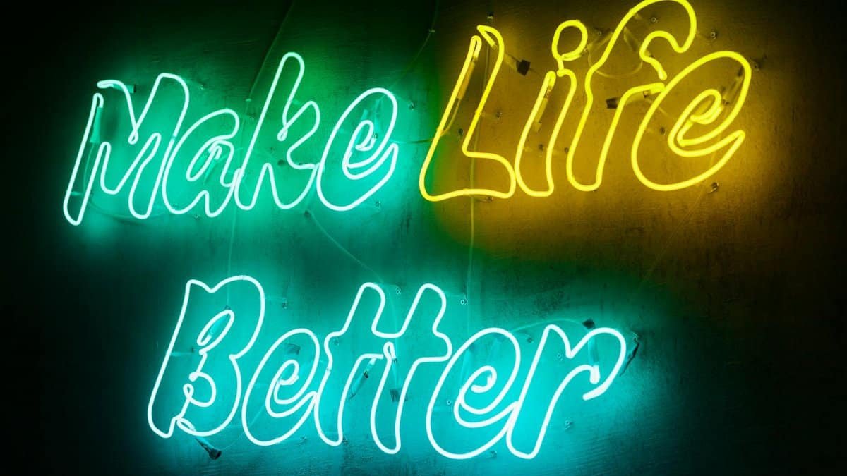 Vivid neon sign displaying the motivational message 'Make Life Better' in a colorful and eye-catching style.