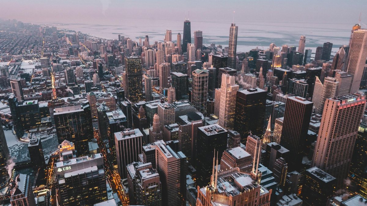 Discover the bustling skyline of Chicago with this twilight aerial cityscape showcasing iconic architecture.