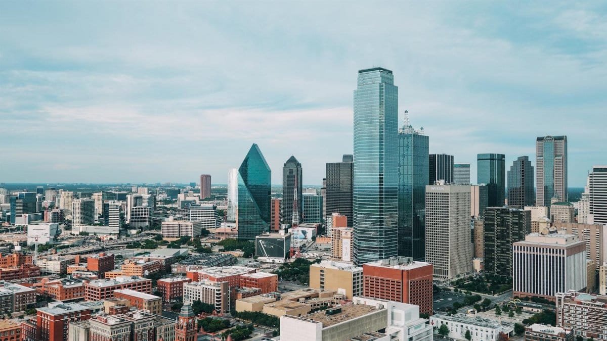 Aerial view of the vibrant Dallas skyline with iconic skyscrapers and urban landscape.