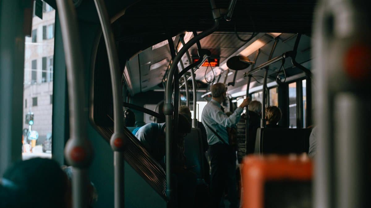 Inside view of a Genoa city bus during a bustling commute, capturing everyday life in Italy.