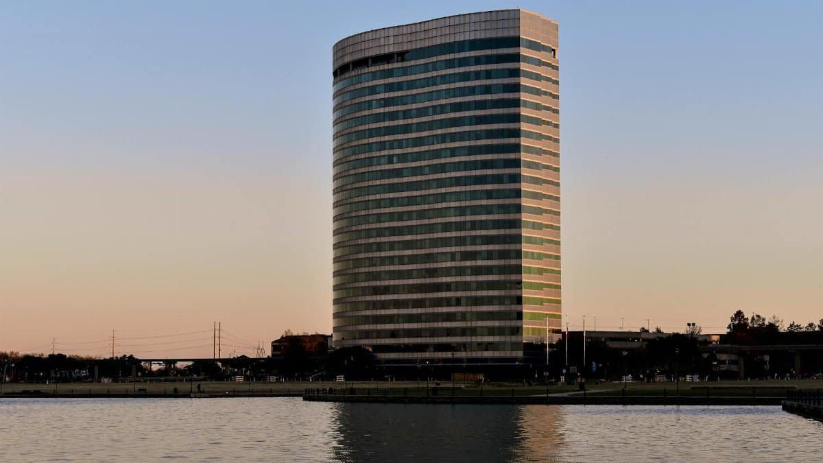 A sleek office building reflected on a lake at sunset in Irving, Texas, USA.