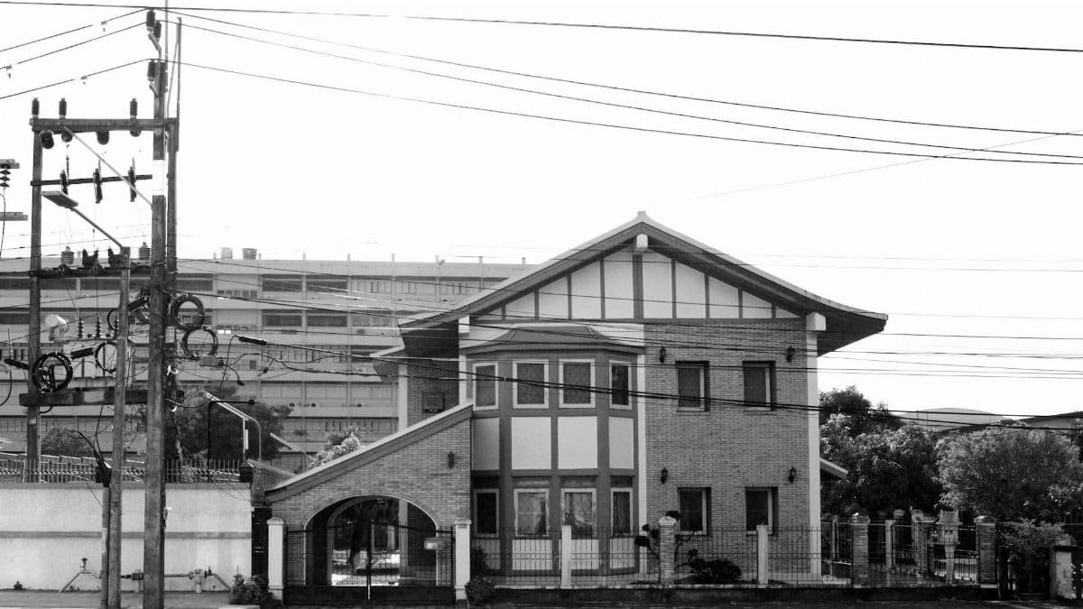 2-storey house with messy utility poles in its front.