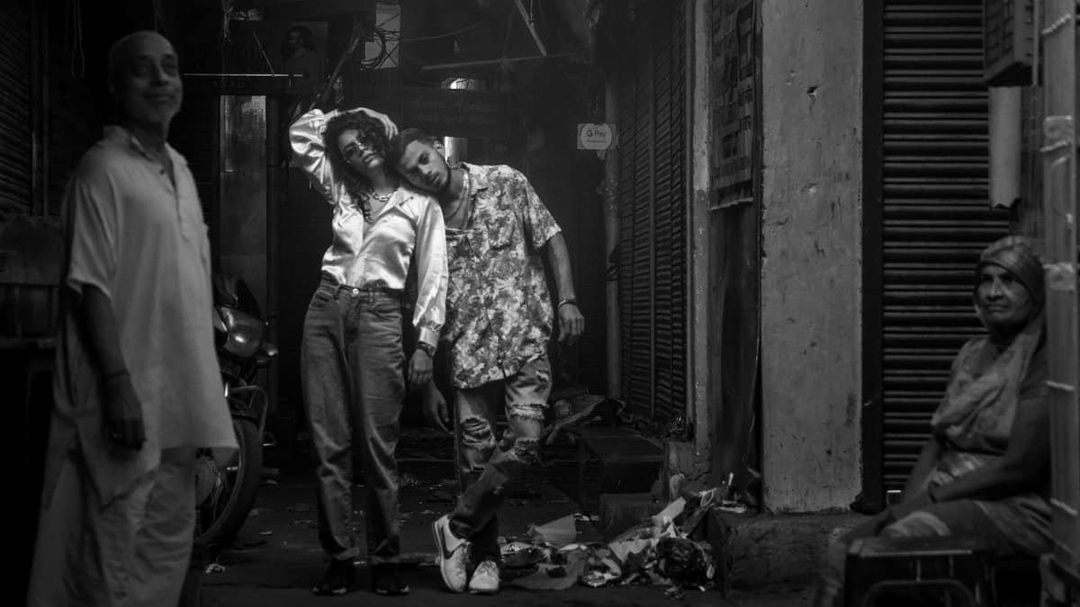 Candid black and white photo capturing diverse individuals in an urban alley.