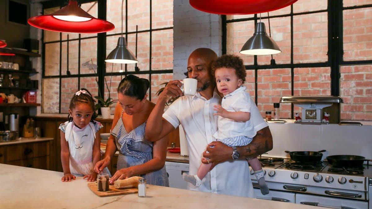 A family enjoying a cooking session together in a modern kitchen, capturing joy and connection.