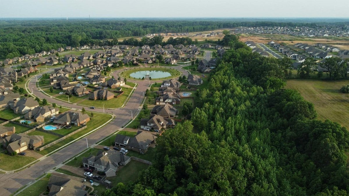 Aerial view showcasing a suburban neighborhood in Memphis, TN with houses and trees.