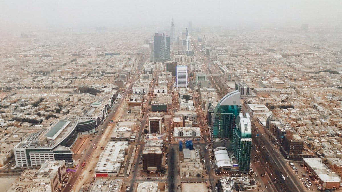 Aerial photograph of Riyadh's modern cityscape with iconic skyscrapers and bustling streets.