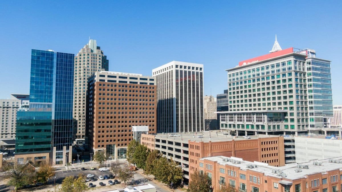 Aerial view of the modern skyline in downtown Raleigh, NC, with clear skies.