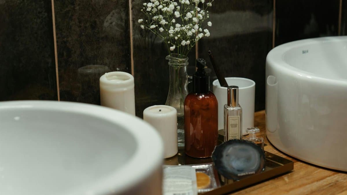 A stylish arrangement of skincare products and candles in a modern bathroom setting, perfect for self-care ambiance.