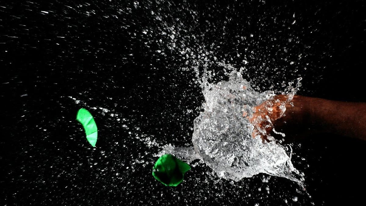 High-speed photograph of water splash capturing motion and liquid dynamics against a dark background.