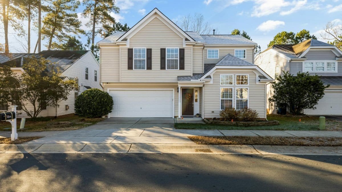 Beautiful modern suburban house with garage and front lawn on a sunny day.
