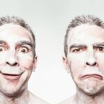 A whimsical portrait showing dual expressions of a man with a painted face.