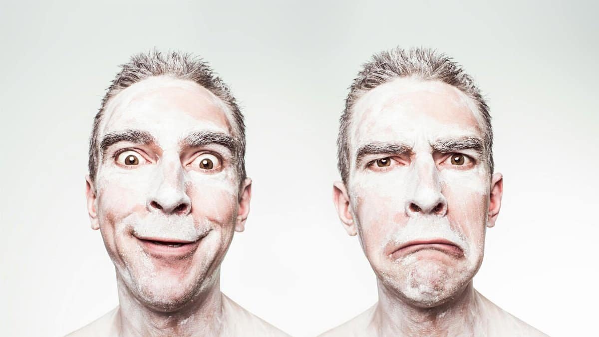 A whimsical portrait showing dual expressions of a man with a painted face.