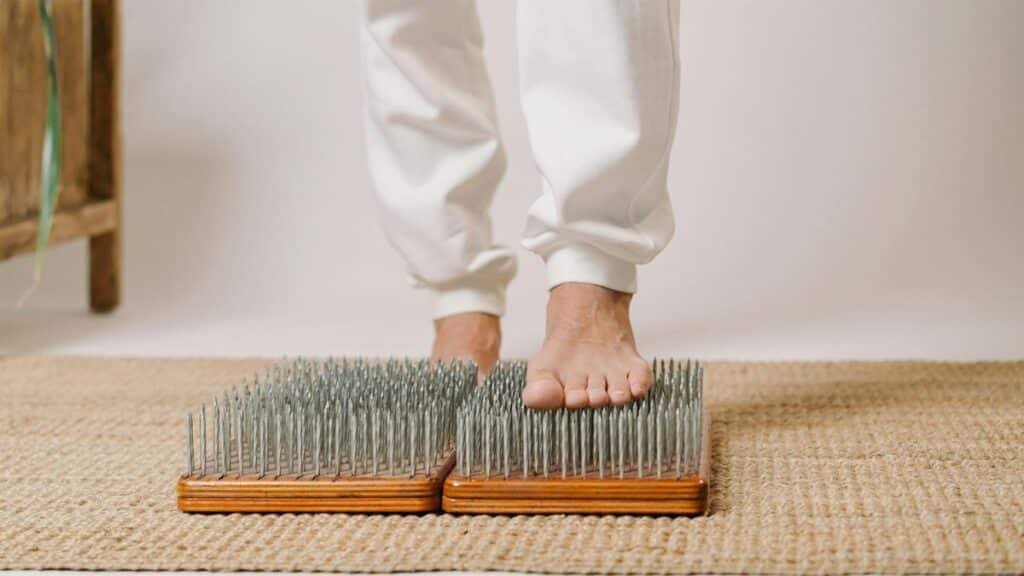 Foot close-up on a sadhu board for alternative healing and wellness practice.