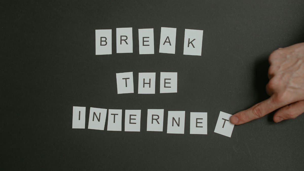 Textual phrase 'Break the Internet' arranged on a black background with a pointing hand.