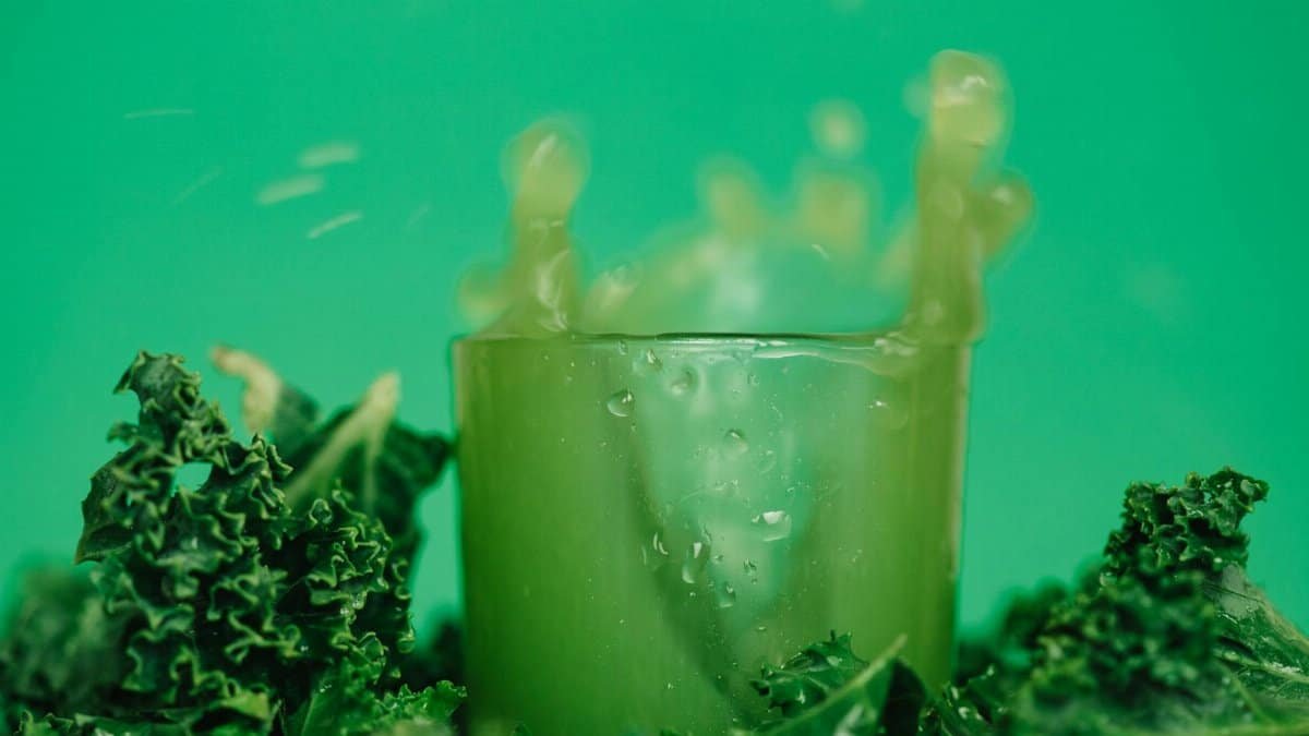 A refreshing kale juice splash showcasing vibrant and healthy lifestyle with green hues.