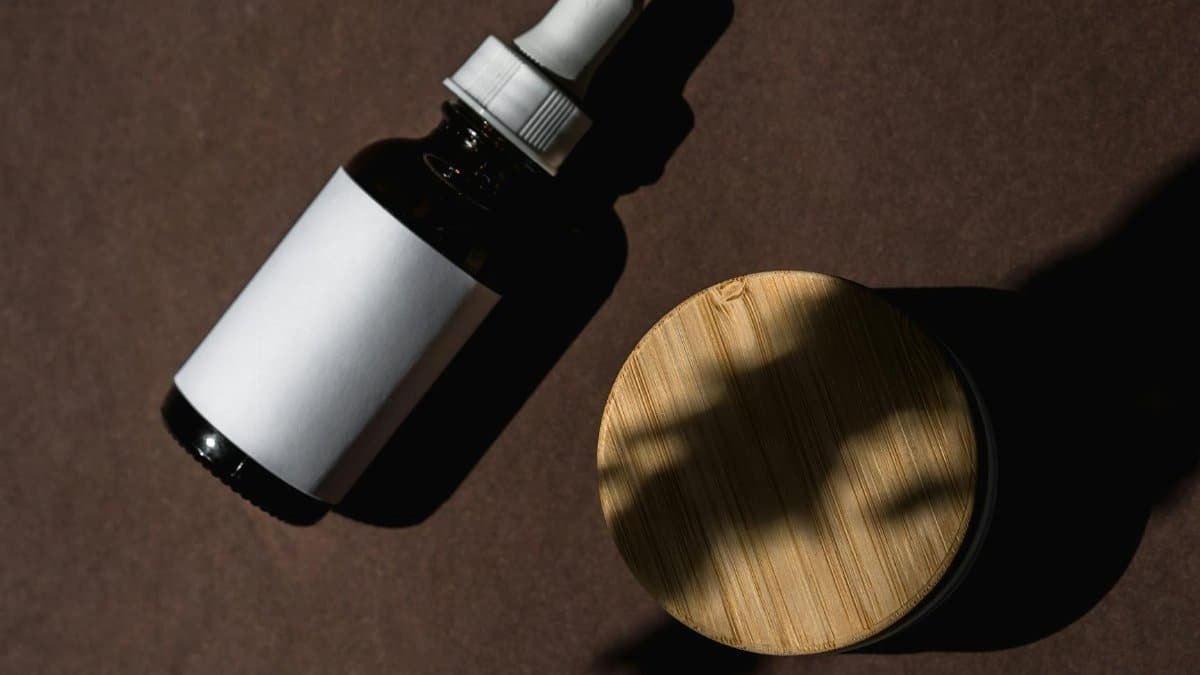 Flat lay of skincare products on a brown surface, showcasing a clean and minimalist design.