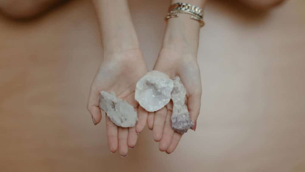 A person's hands holding healing crystals, perfect for meditation and mindfulness themes.