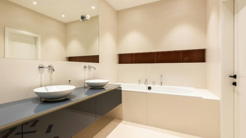 Sleek modern bathroom with double sinks and a stylish bathtub.