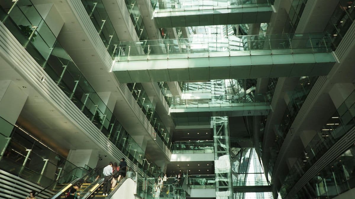 Interior view of a modern building with glass walkways and multiple levels.