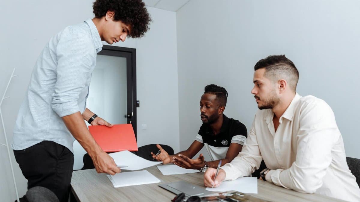 A diverse business team engaged in a creative work session in a modern office setting.