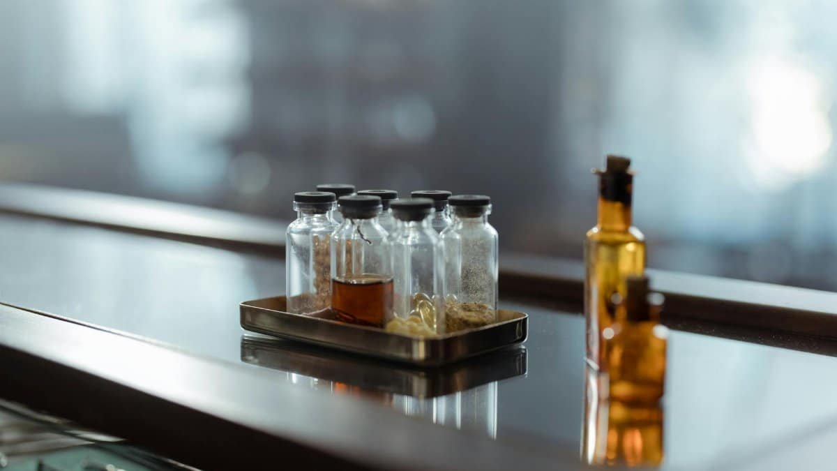 A captivating arrangement of medicine bottles on a reflective surface, evoking a sense of chemistry and alchemy.