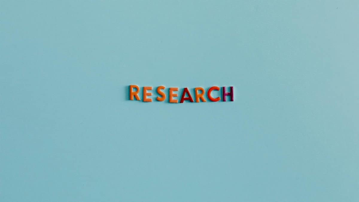 Colorful uppercase letters spelling 'RESEARCH' on a soft blue background. Ideal for education and science topics.