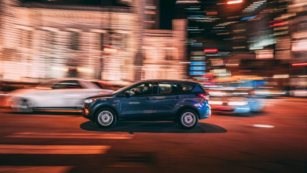 Dynamic long exposure of an SUV speeding through nighttime streets in Chicago.