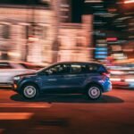 Dynamic long exposure of an SUV speeding through nighttime streets in Chicago.