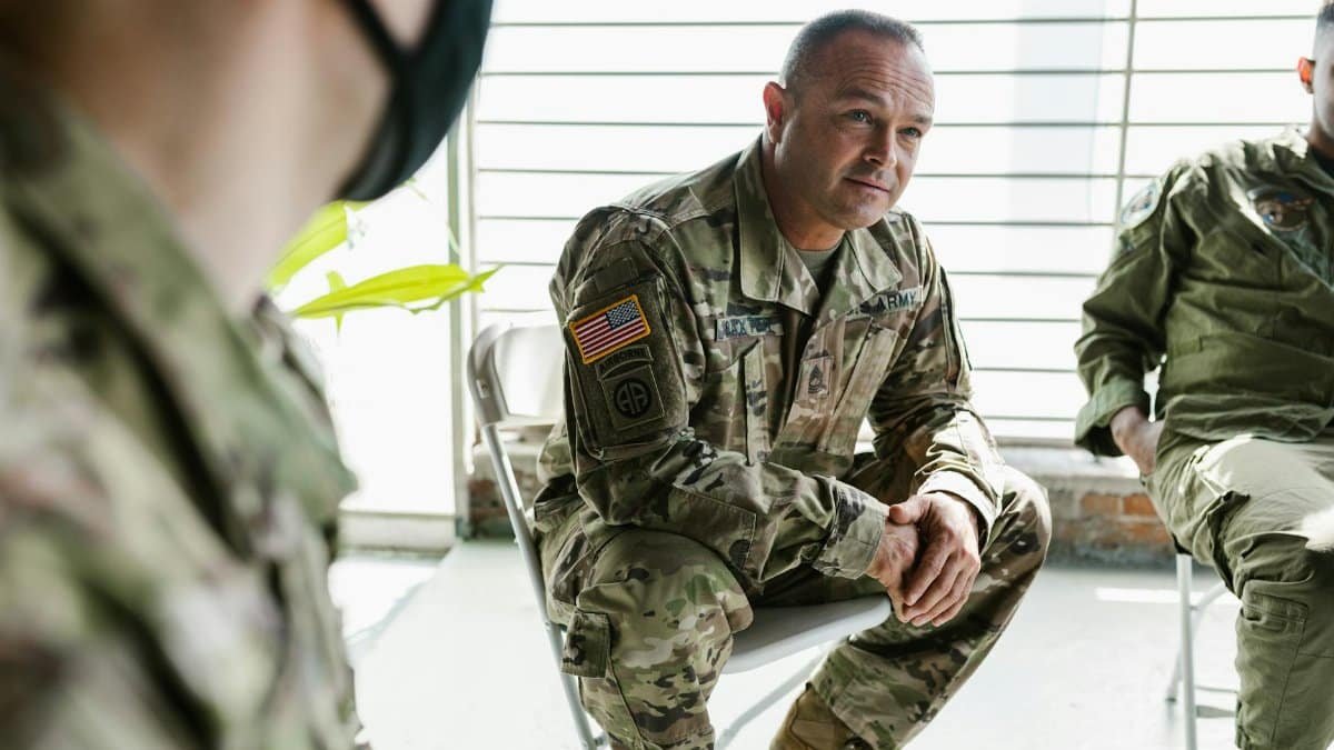 Military veterans participate in a group therapy session to support mental health recovery.