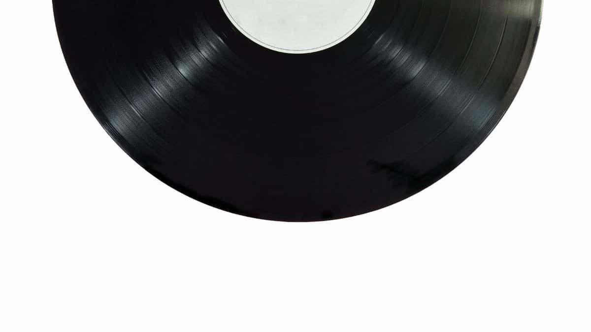 A classic black vinyl record isolated on a white background.