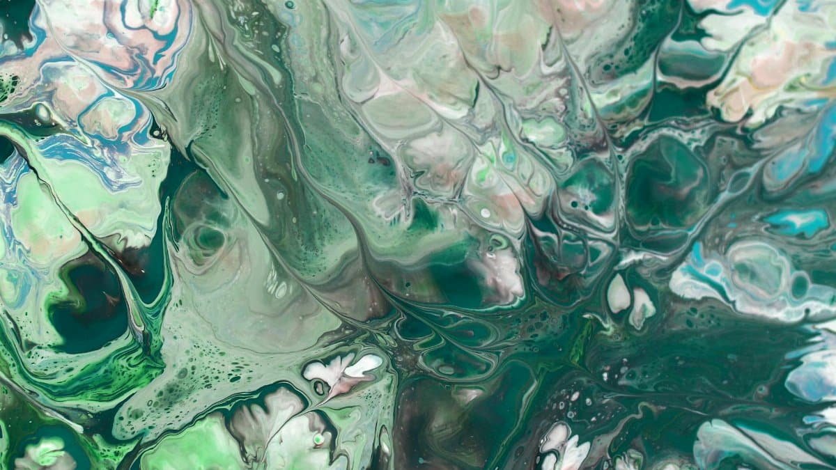 A mesmerizing abstract fluid art piece with swirling green and blue patterns creating a calm and dynamic visual.