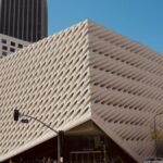 Modern architectural shot of The Broad Museum in Los Angeles under a clear blue sky.