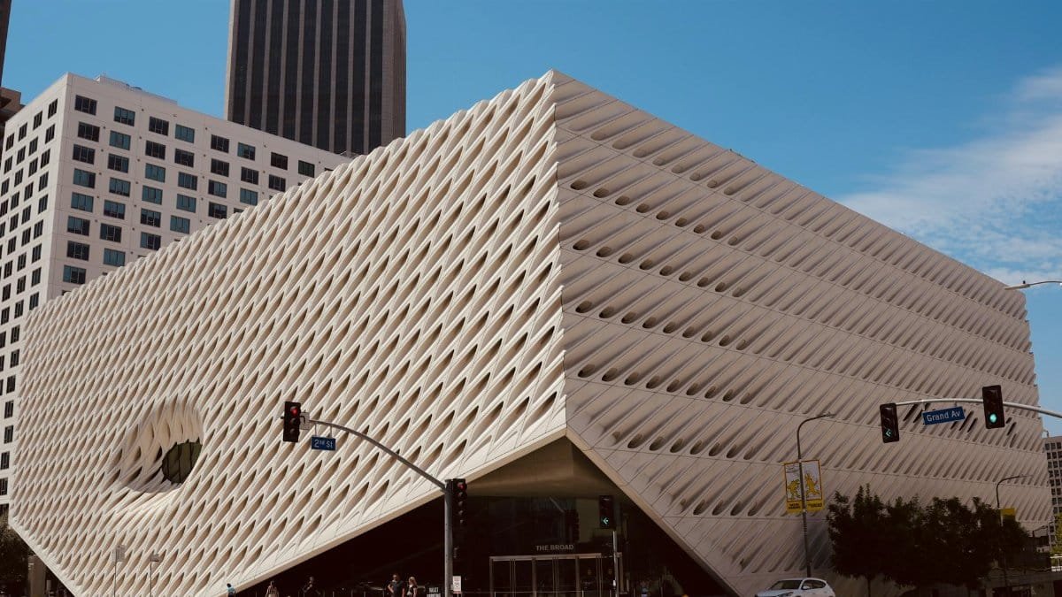 Modern architectural shot of The Broad Museum in Los Angeles under a clear blue sky.
